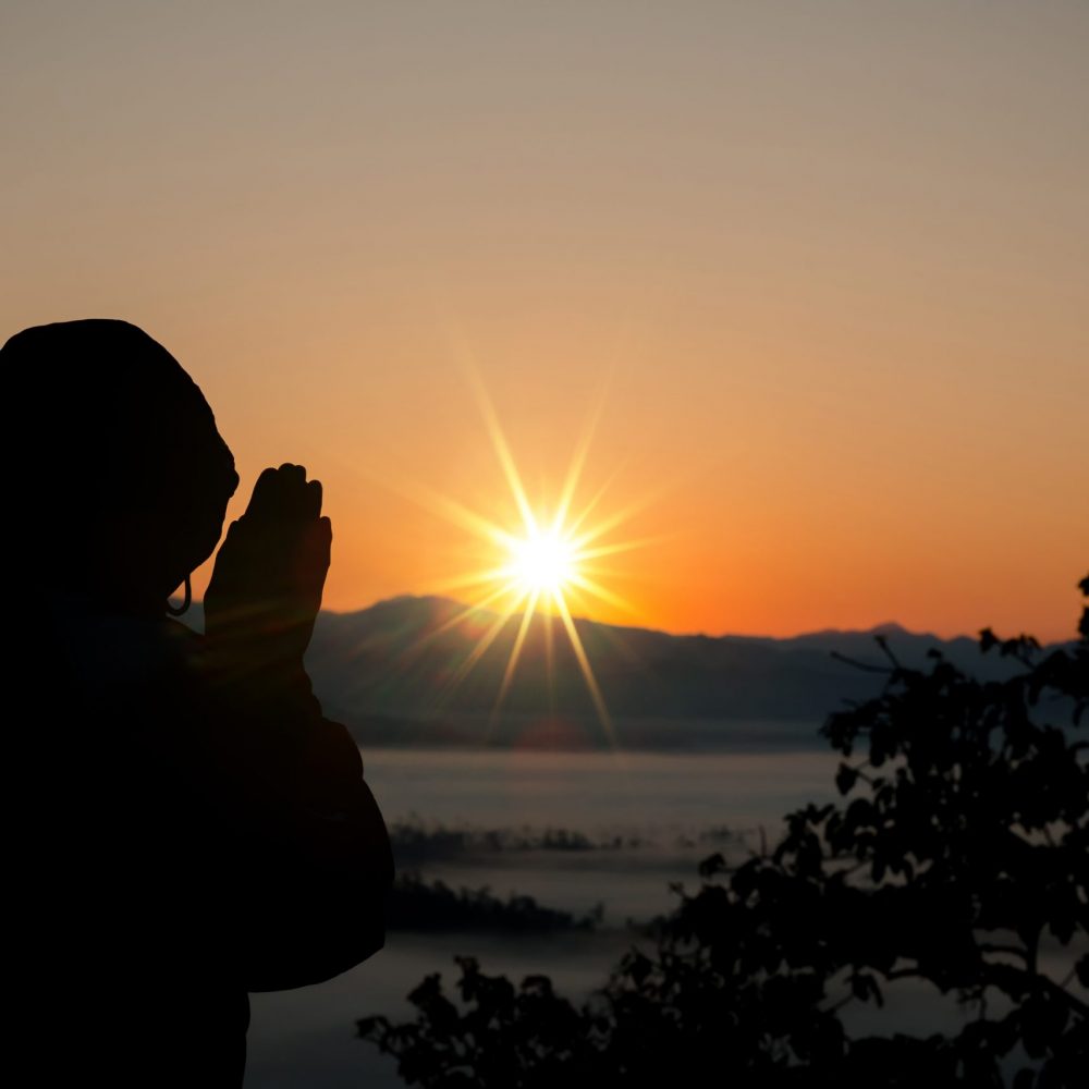 Silhouette of christian man hand praying,spirituality and religion,man praying to god. Christianity concept.